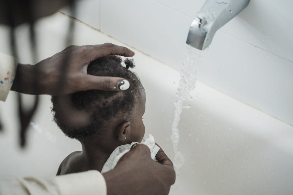 Close-up of Father Bathing His Daughter