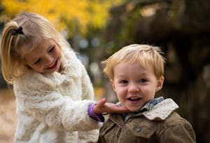 Girl Holding the Chin of Boy Outdoor