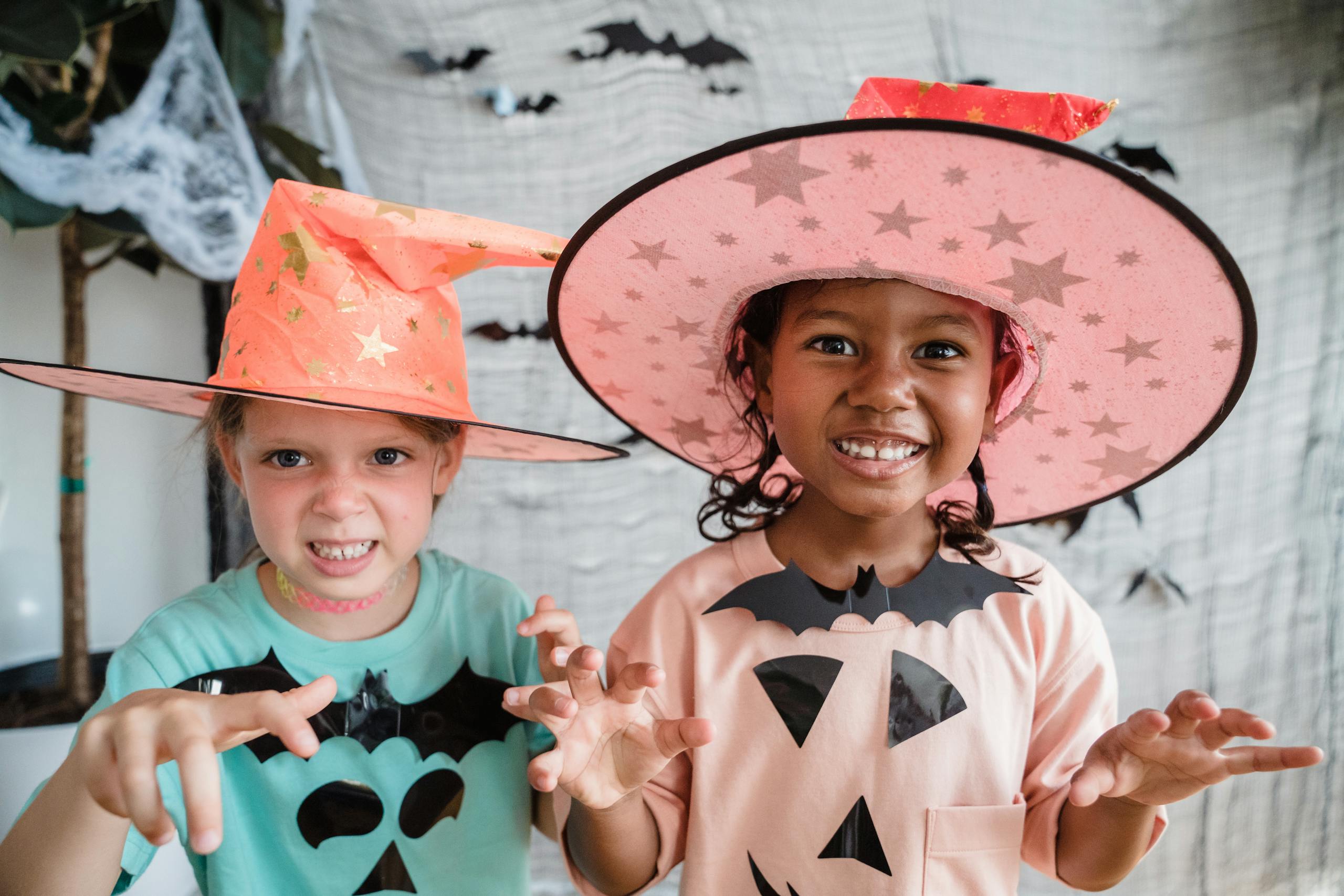 Little girls in halloween costumes making scary faces