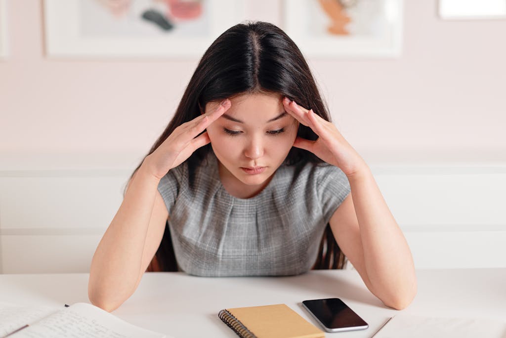 Photo of a Woman with Her Hands on Her Head